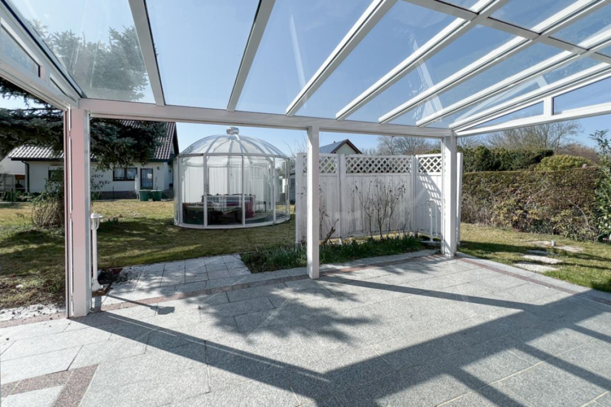 Überdachte Terrasse mit Whirlpool im Garten