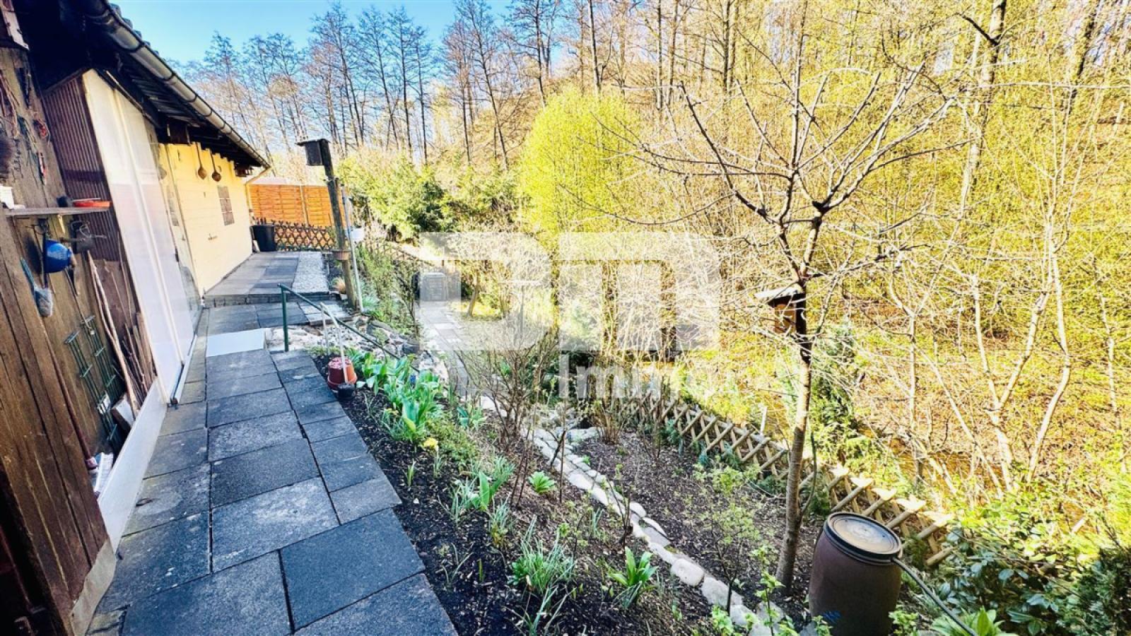Gartenbereich hinter den Carports mit Bachlauf