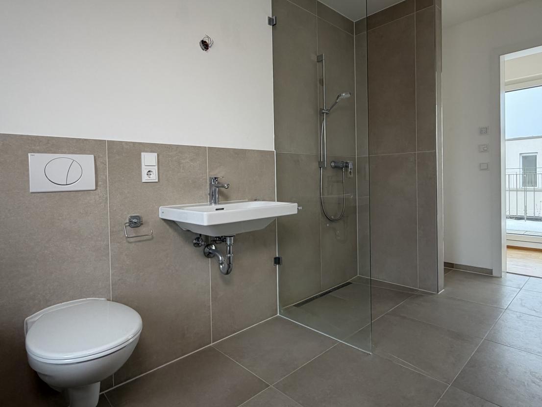 Badezimmer mir Badewanne und offener Dusche