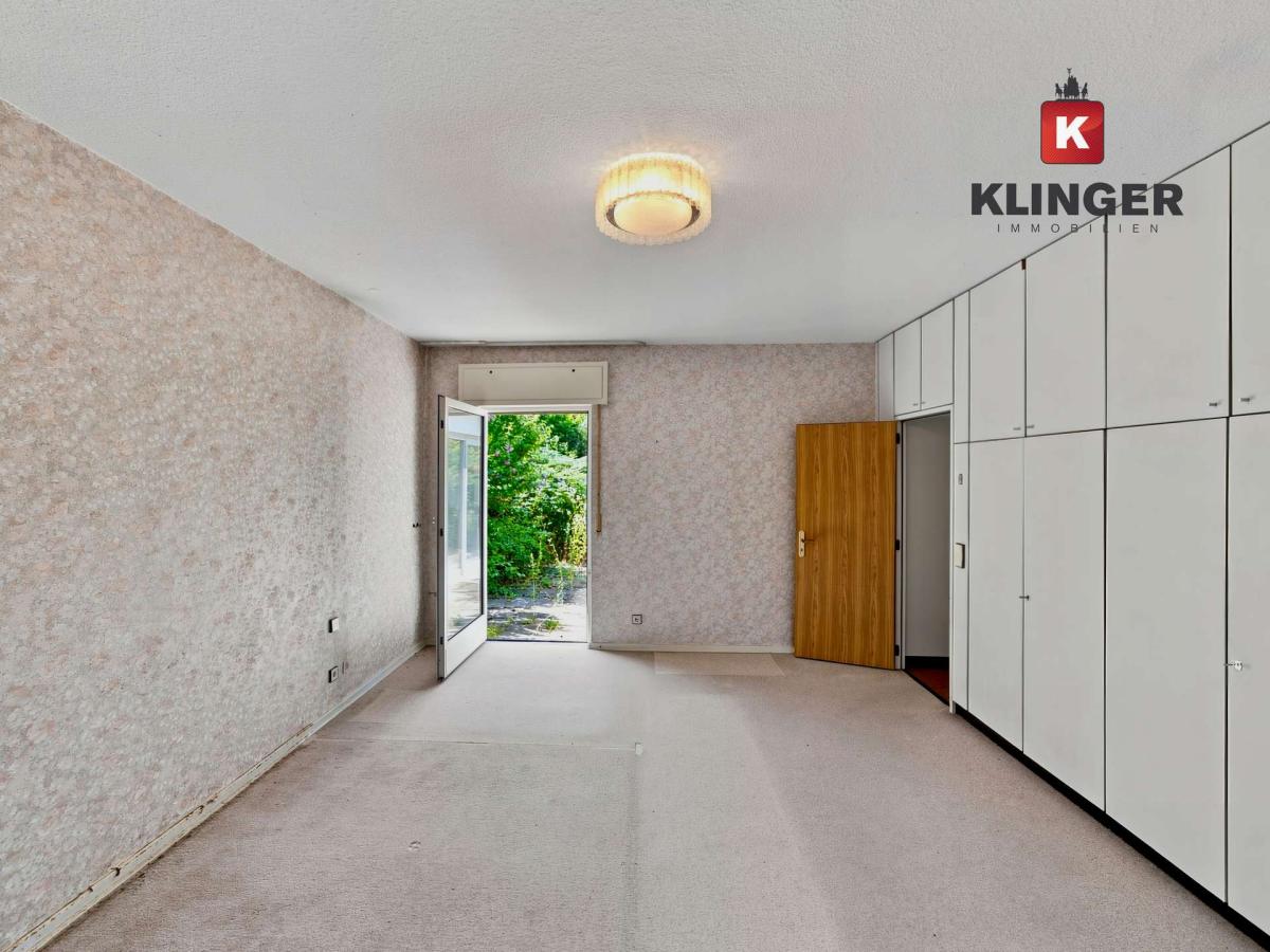 Schlafzimmer mit Einbauschränken und Zugang zum Außenbereich